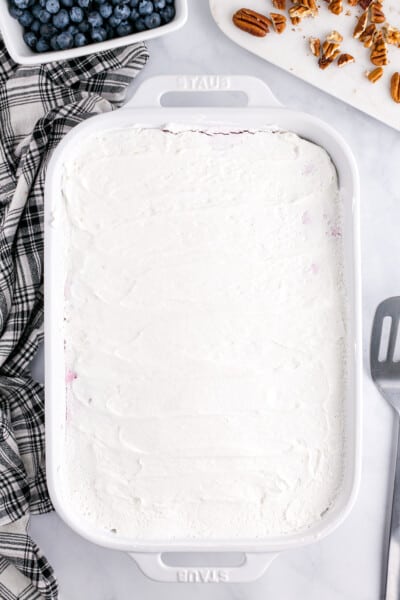 cool whip spread over the top of the pie filling