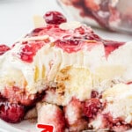 A piece of heaven on earth cake is on a plate with a bite taken out of it.
