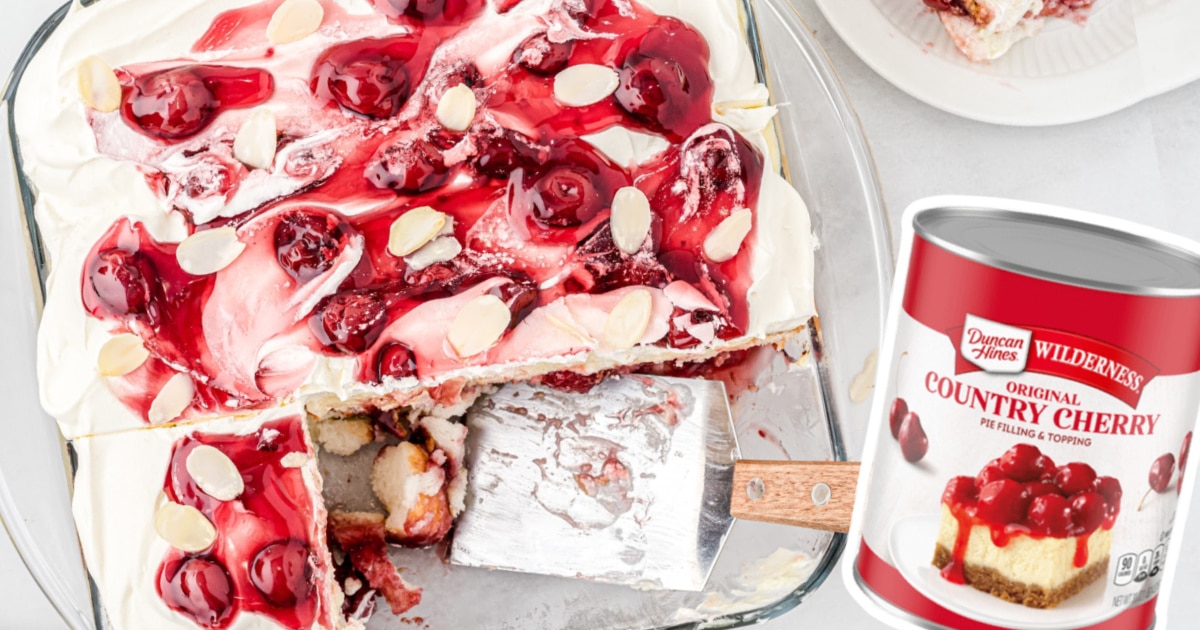 An overhead view of a heaven on earth cake in a baking dish with a few pieces missing from it.