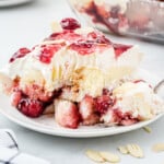 A fork has removed a bite of heaven on earth cake from a slice.