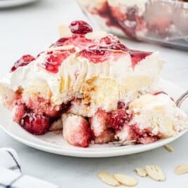 A fork has removed a bite of heaven on earth cake from a slice.