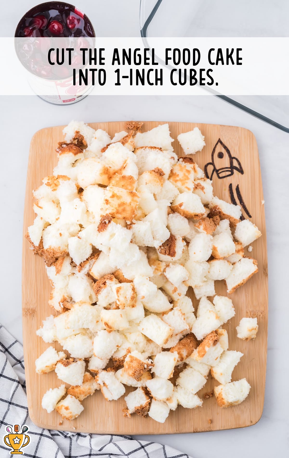 The angel food cake has been cut into cubes.