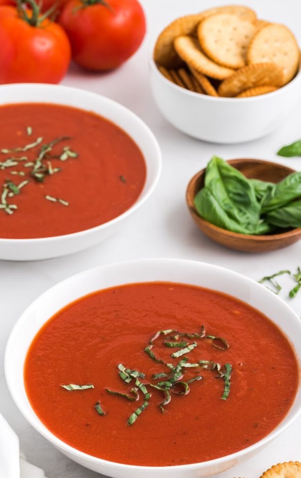A bowl of soup on a table, with Tomato soup