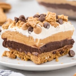 Recipe card graphic for peanut butter dream bars featuring a close-up of a layered dessert made with chocolate pudding, peanut butter filling, and whipped topping. Includes Skippy peanut butter and Jell-O pudding boxes with a text list of ingredients for an easy, no-bake chocolate peanut butter dessert.