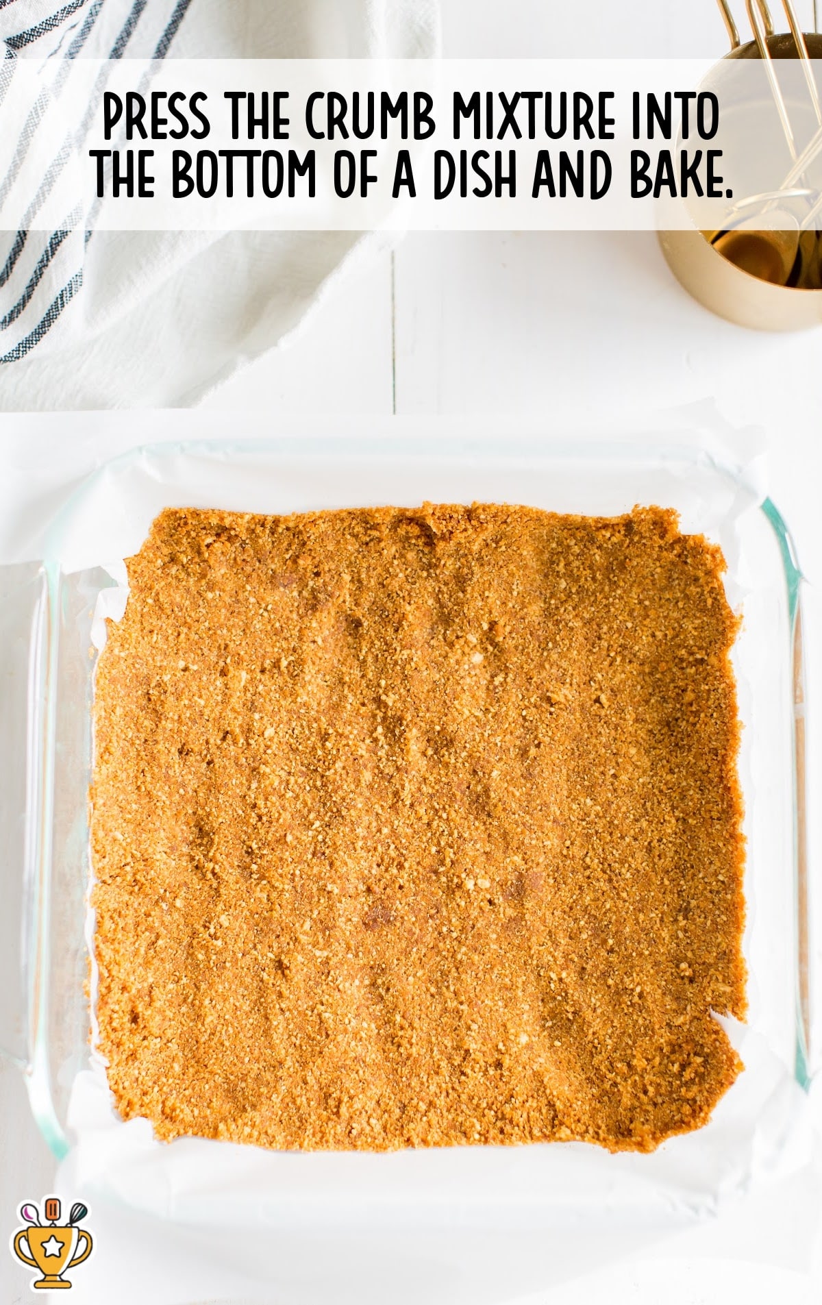 Gingersnap cookie crumb crust pressed evenly into a glass baking dish, ready to bake for the base of pumpkin cheesecake bars.