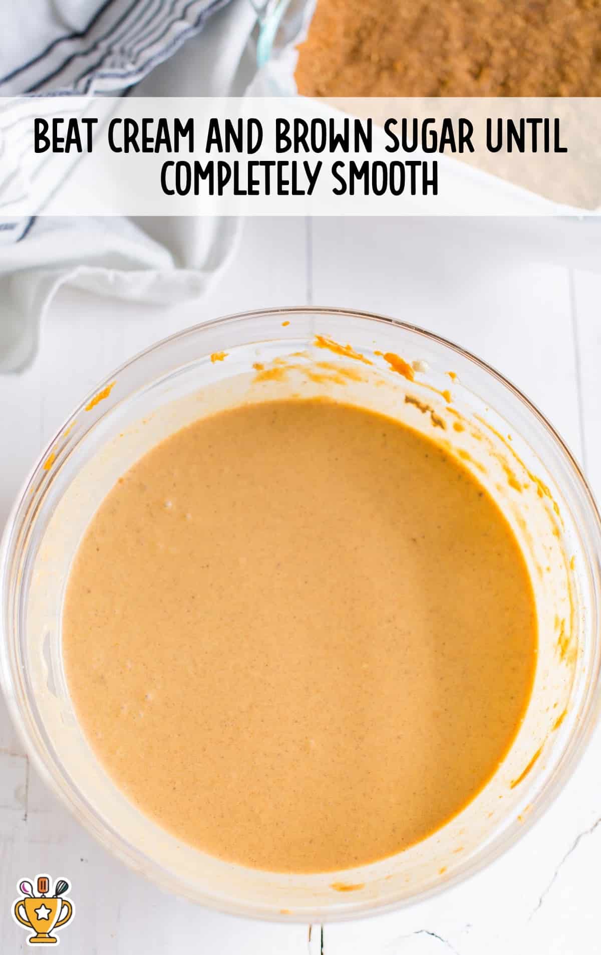 Smooth pumpkin cheesecake filling made with cream cheese, brown sugar, and pumpkin purée in a mixing bowl, ready to pour over the crust.