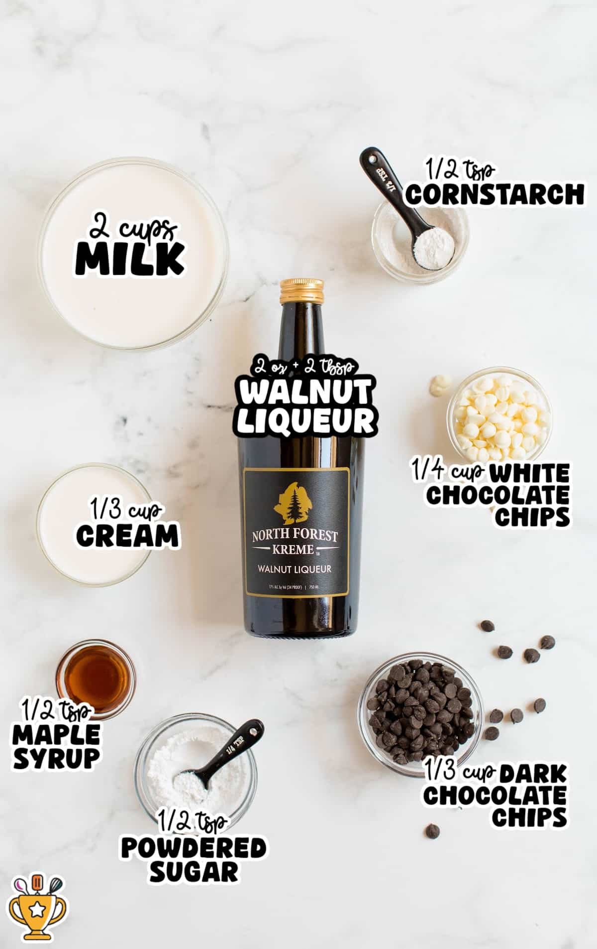 Ingredients for spiked hot chocolate recipe — milk, cream, walnut liqueur, white and dark chocolate chips, maple syrup, cornstarch, and powdered sugar arranged on a marble surface.