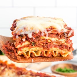 A close up of a sandwich on a plate, with Lasagna