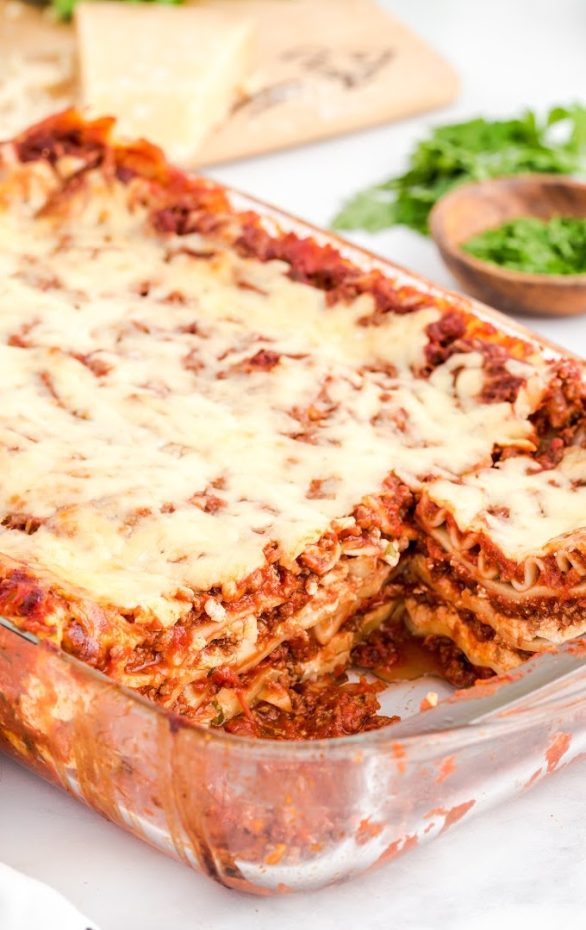 A piece of food on a plate, with Lasagna and Cheese