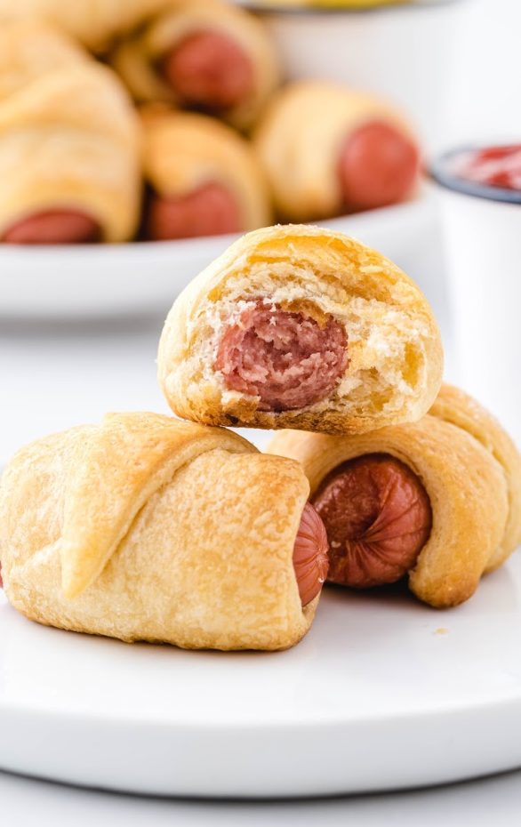 A close up of food on a plate, with Pigs in a blanket and Cocktail wieners