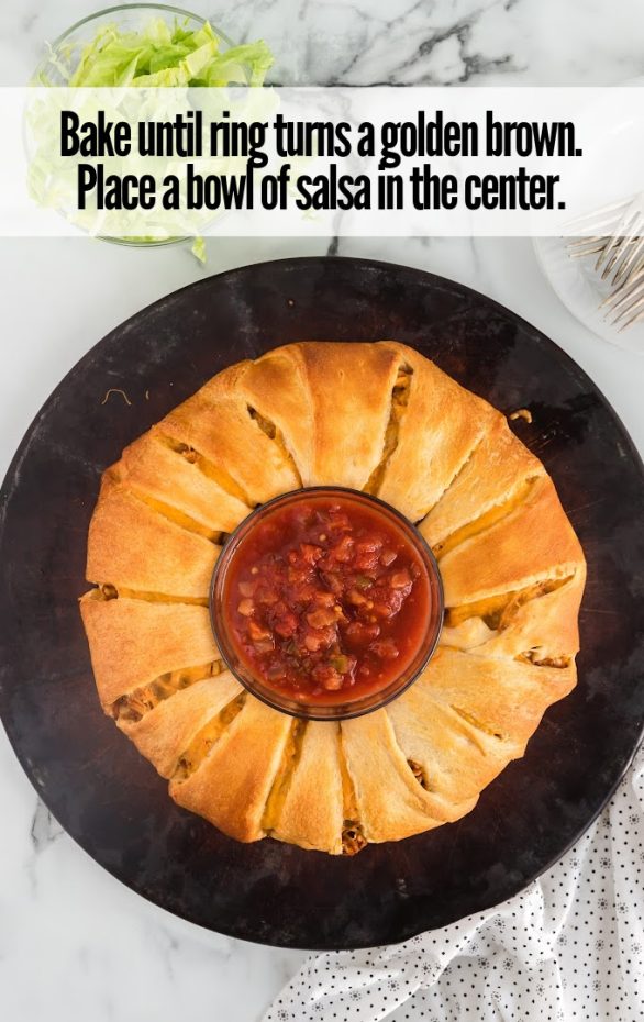 A pan of food on a plate, with Taco and Cheese
