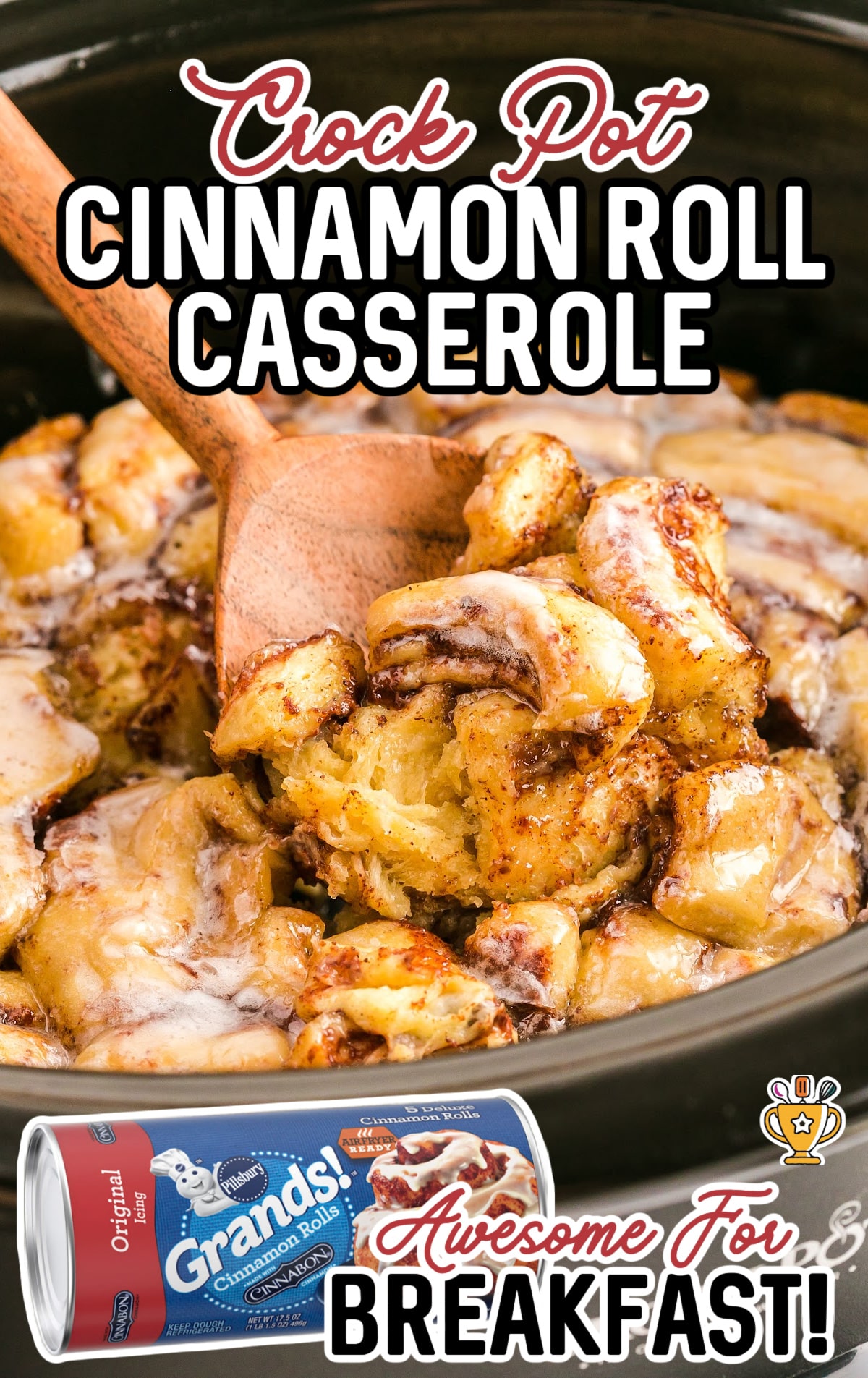 A wooden spoon is lifting a big scoop of crock pot cinnamon roll casserole out of the slow cooker.