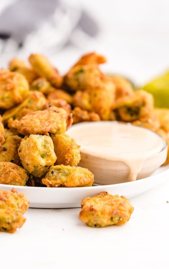 A plate of food, with Fried pickle and Dipping sauce