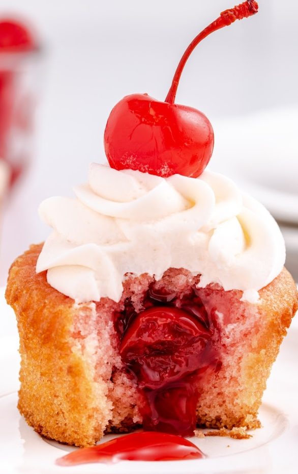 A close up of a piece of cake on a plate, with Cupcake and Cherry