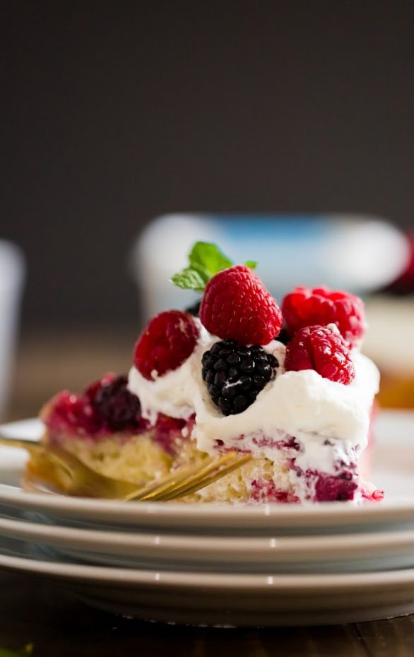 A close up of a slice of cake on a plate, with Berry and Cream