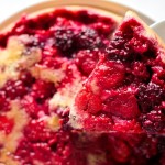 A close up of a plate of pizza, with Berry and Cake