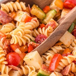 A dish is filled with food, with Pasta and Salad