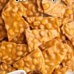 Top view of shiny golden peanut brittle pieces scattered across parchment paper with a holiday tin graphic and text overlay explaining how to make peanut brittle.