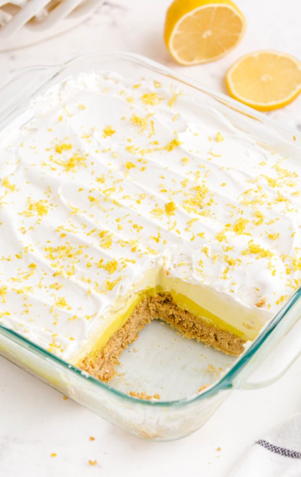 A piece of cake on a plate, with Lemon and Cream