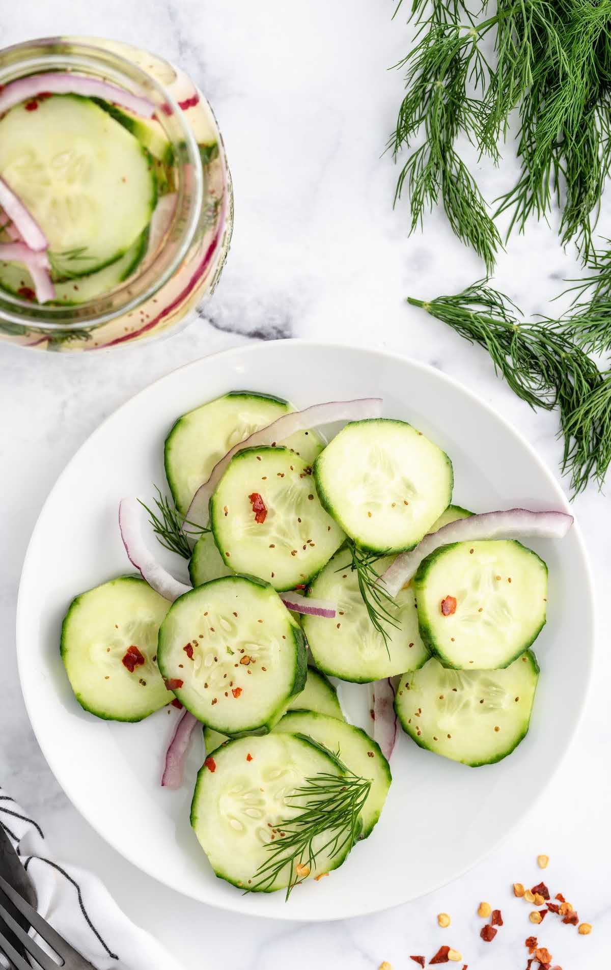 A plate of food on a table, with Cucumber and Salad
