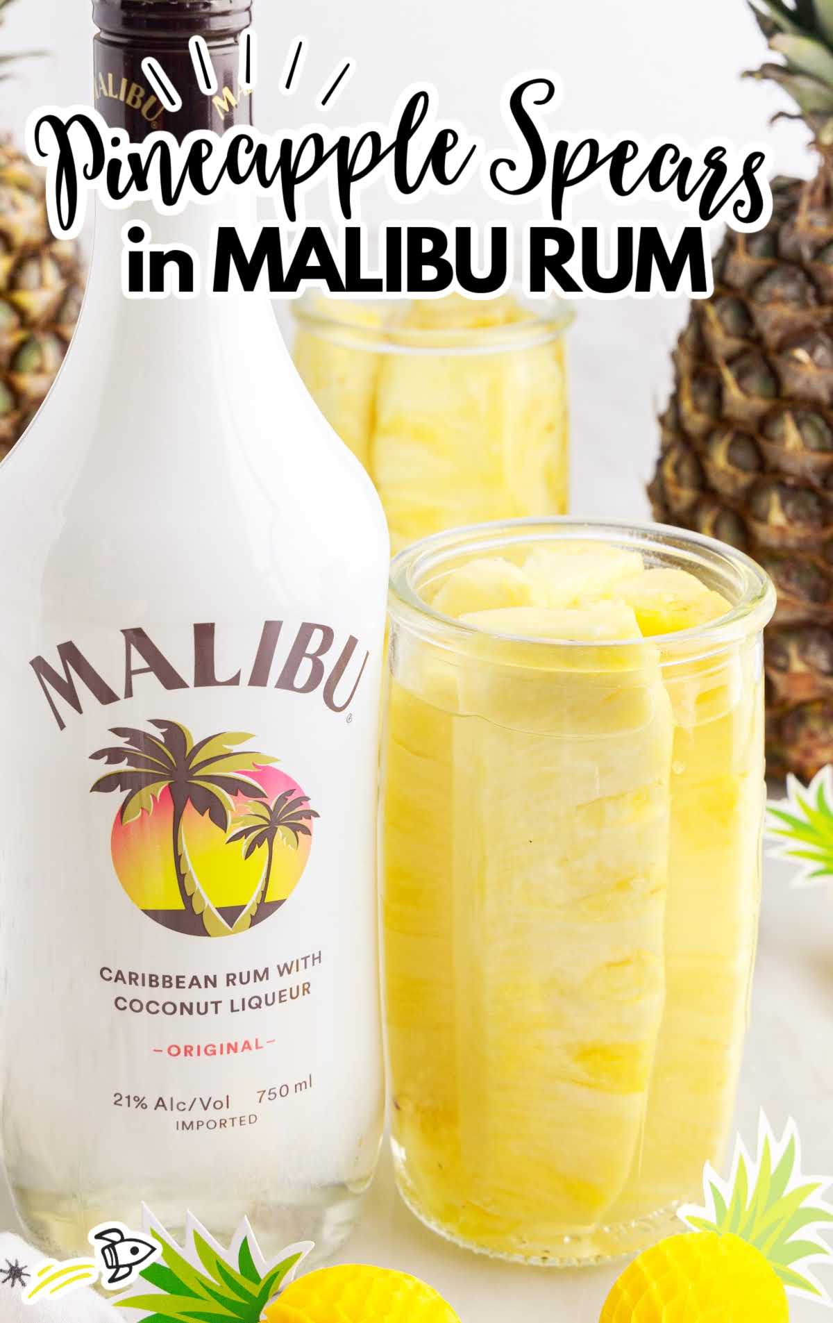 A close up of a bottle and a glass of orange juice, with Pineapple and Malibu