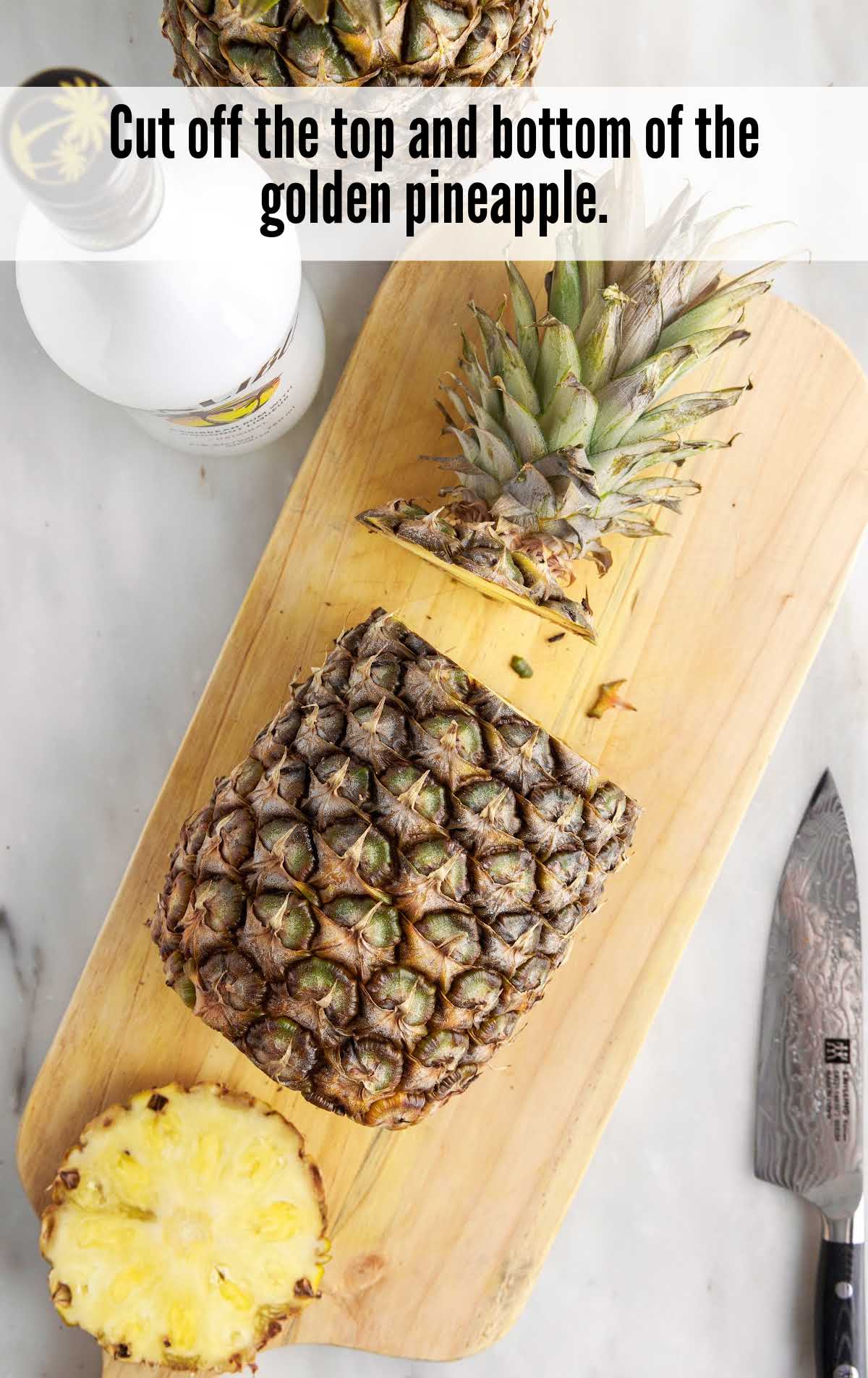 A banana sitting on top of a wooden cutting board, with Pineapple and Malibu