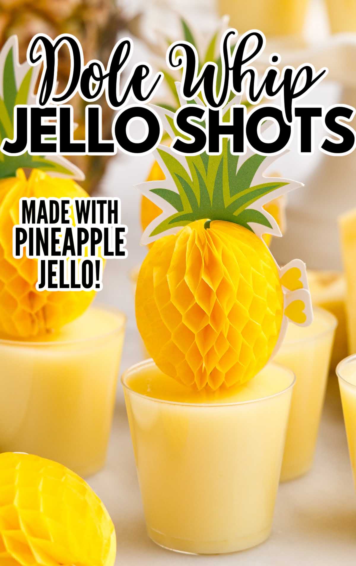 A glass of orange juice, with Jello shot and Pineapple
