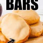 Maple bars stacked on a white plate, each topped with a thick layer of light brown maple glaze. A black arrow and bold white text overlay at the top and bottom of the image reads “Easy 15 Minute Maple Bars – Quick and Easy!”