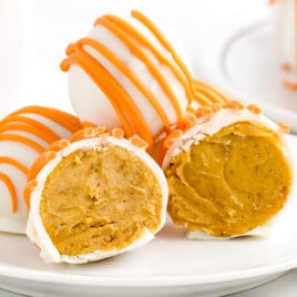 A dessert plate with a few No Bake Pumpkin Cheesecake Balls on it.