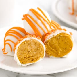 A close up shot of No Bake Pumpkin Cheesecake Balls on a dessert plate.