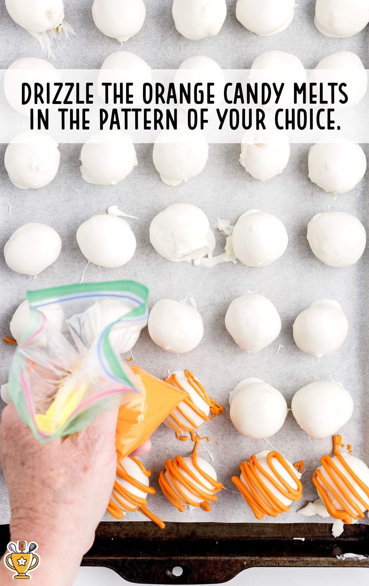 The cheesecake balls are drizzled in melted orange candy.