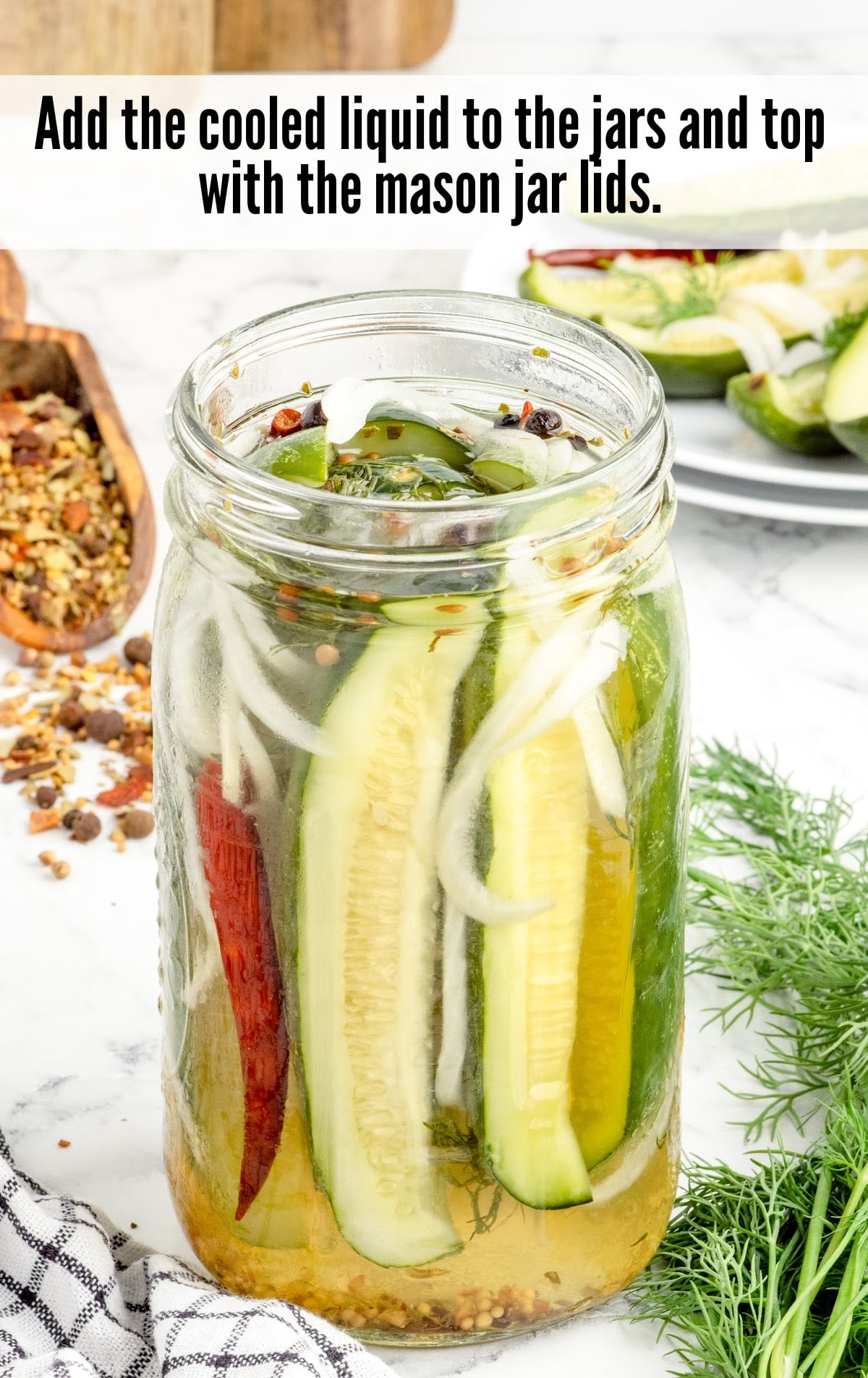 A close up of food on a table, with Refrigerator pickles and Dill