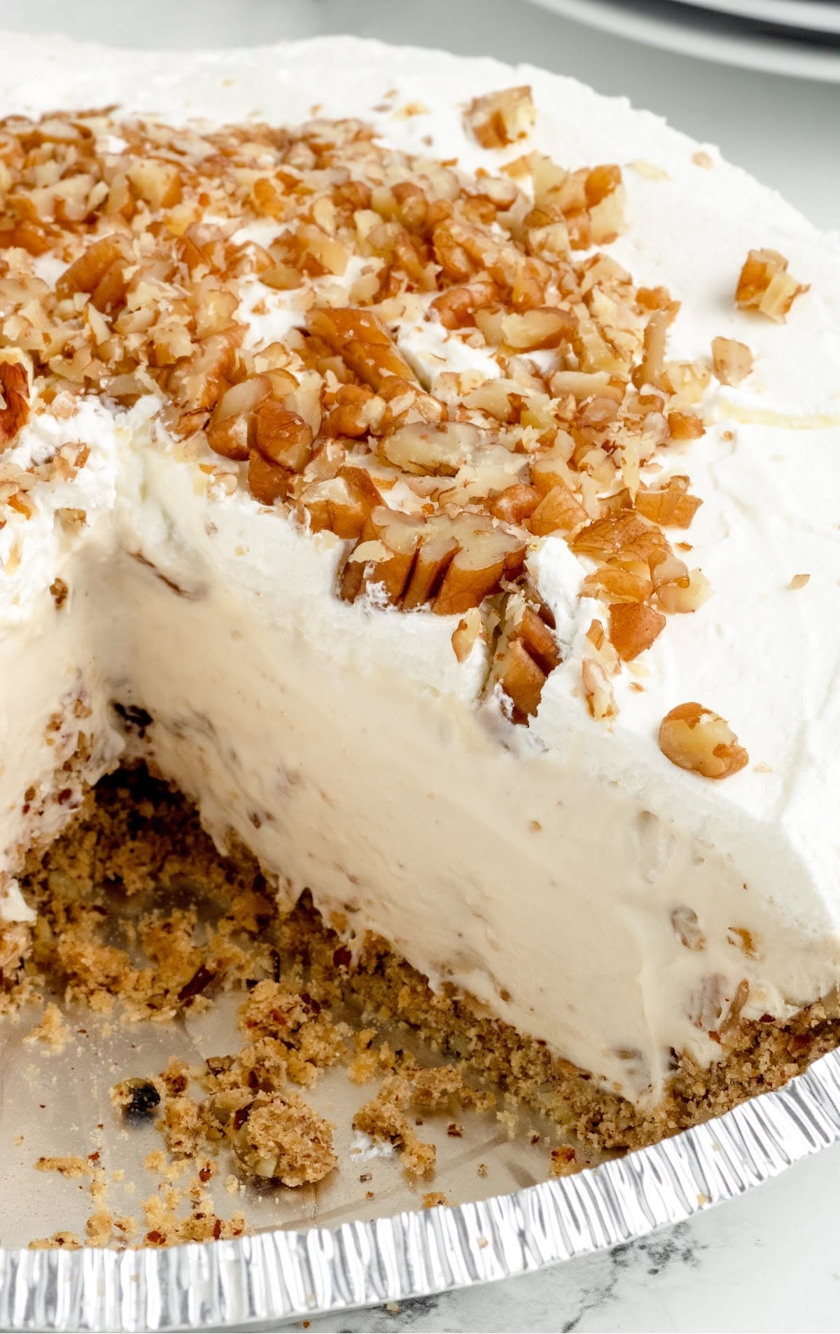 A piece of cake on a plate, with Pecan and Cream