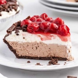 A piece of chocolate cake on a plate, with Cheesecake