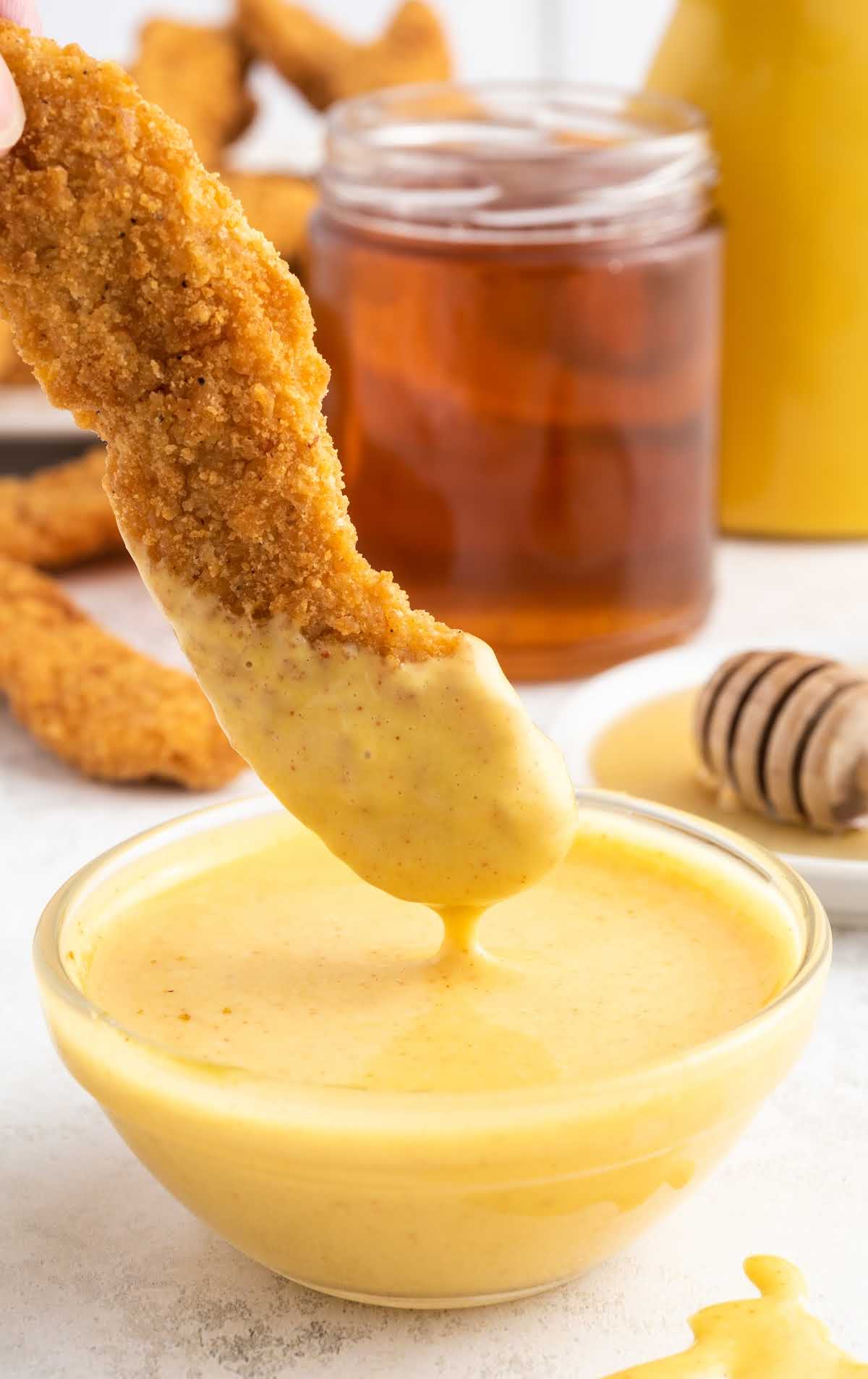 A close up of food on a table, with Sauce and Mustard