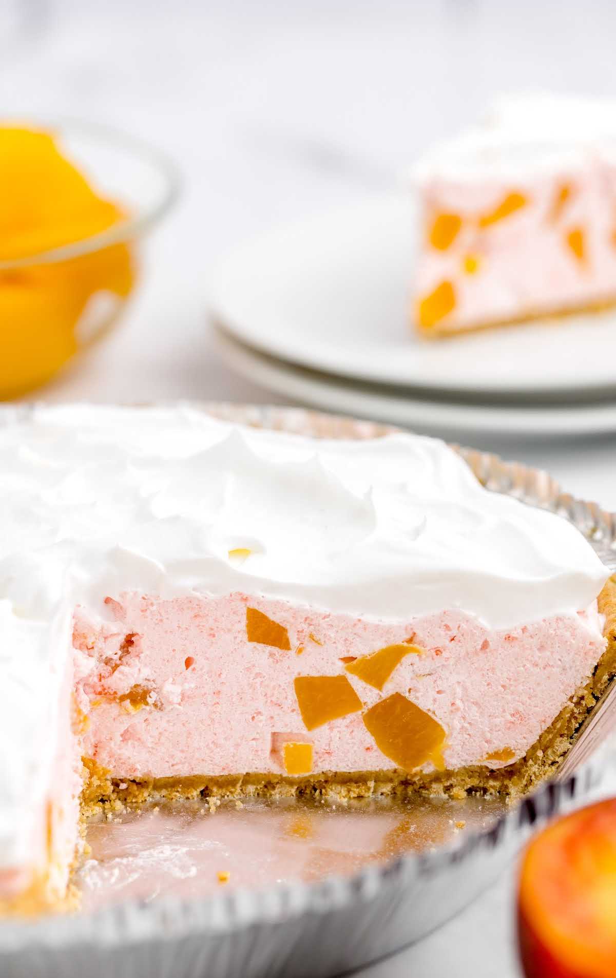 A piece of cake on a paper plate, with Peach and Cool Whip