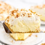 A slice of No Bake Coconut Cream Pie on a pie lifter.