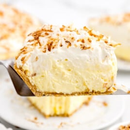 A slice of No Bake Coconut Cream Pie on a pie lifter.