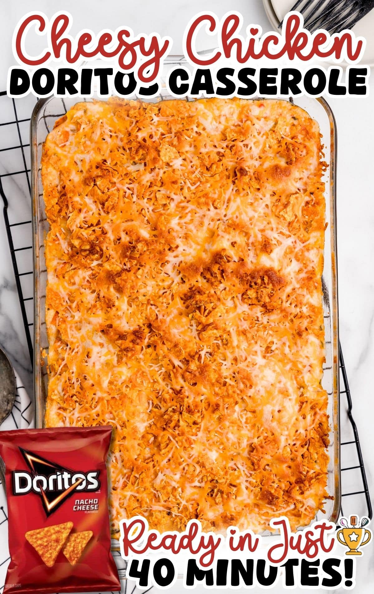 Cheesy chicken Doritos casserole baked until golden and bubbly in a rectangular glass baking dish on a wire rack.