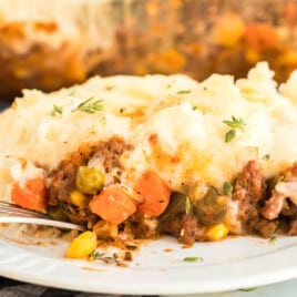 A serving of shepherd's pie on a white plate.
