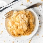 overhead shot of a bowl of Funeral Potatoes with a fork
