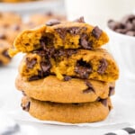 A stack of gooey looking pumpkin chocolate chip cookies.