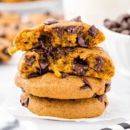 A stack of gooey looking pumpkin chocolate chip cookies.