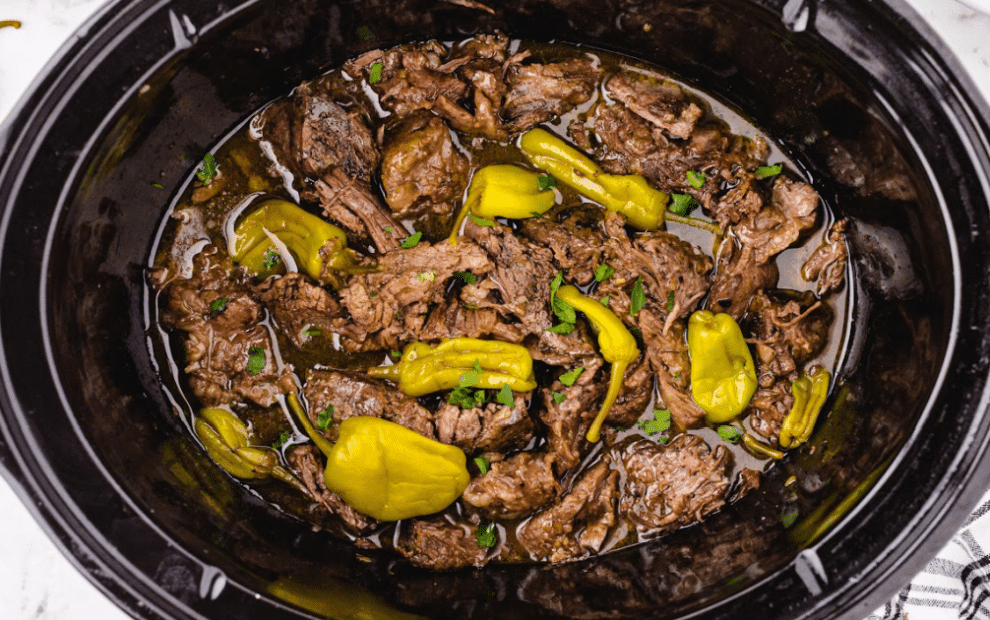 meat in the slow cooker finished and fork tender with pepperoncini's