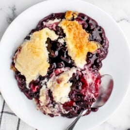 blueberry cream cheese dump cake on a plate with spoon