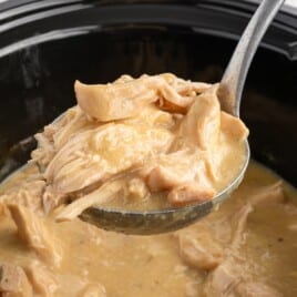 Recipe card image showing mashed potatoes topped with chicken and gravy next to a crockpot full of shredded chicken, with full ingredient list displayed.