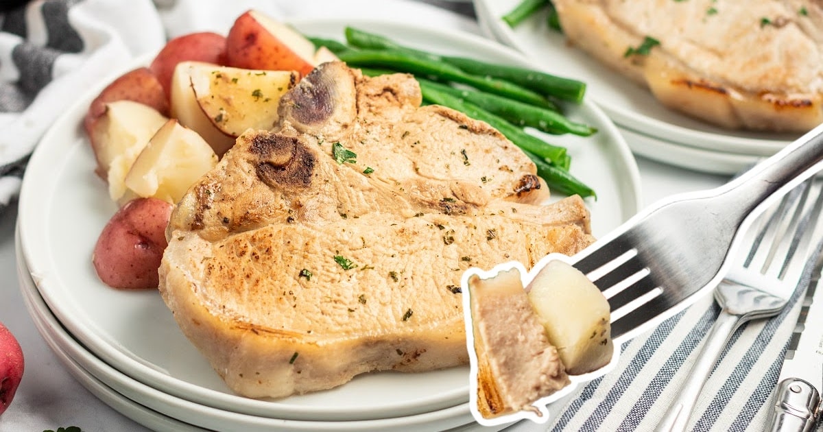 plate of pork chops served with diced red potatoes and green beans