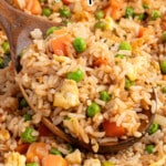 Easy Chinese fried rice made with rice, scrambled eggs, carrots, peas, and savory sauce.