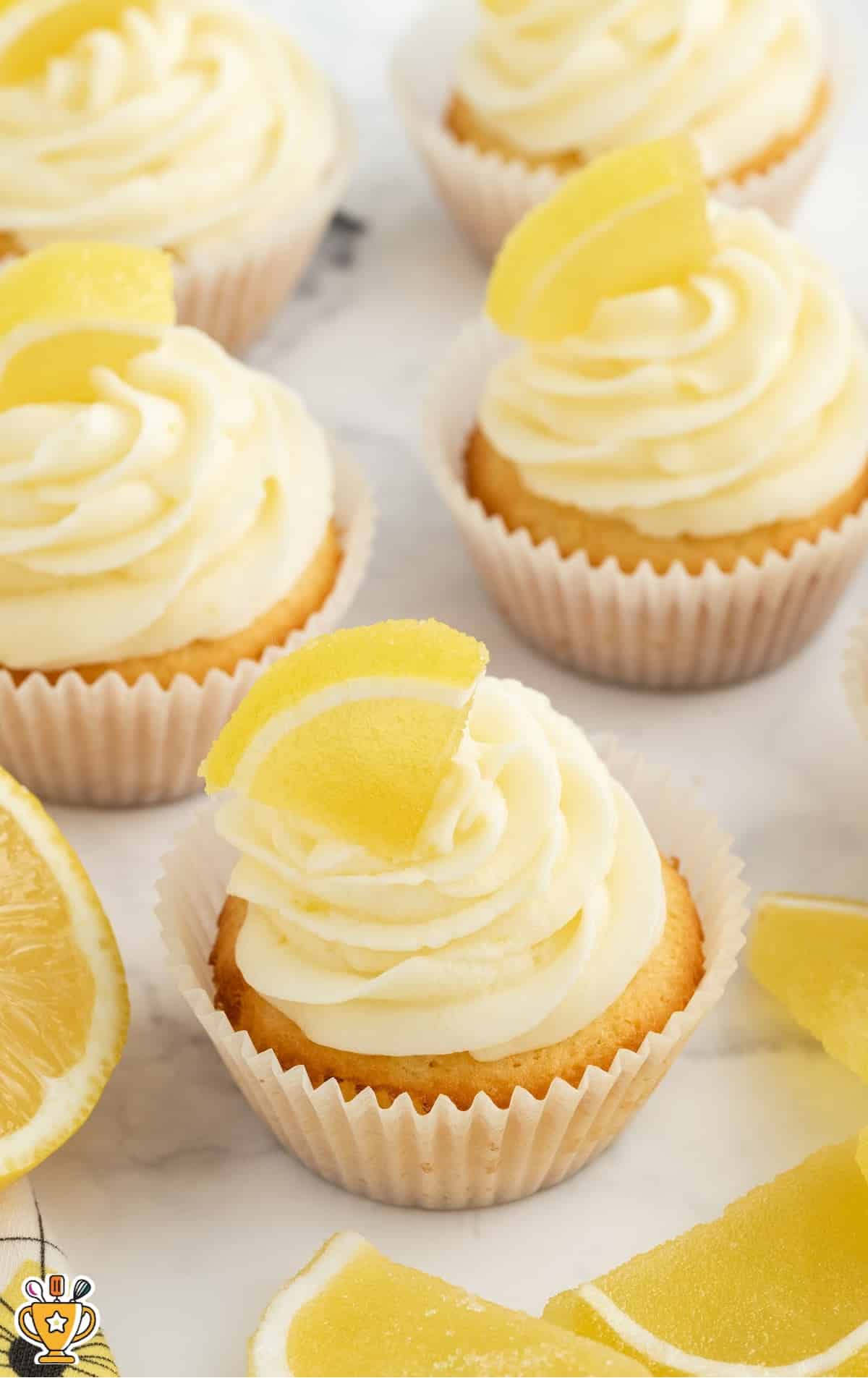 Lemon Cupcake on a plate topped with a slice of lemon and frosting