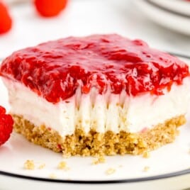 a slice of No Bake Raspberry Cheesecake on a plate with a bite taken out of it